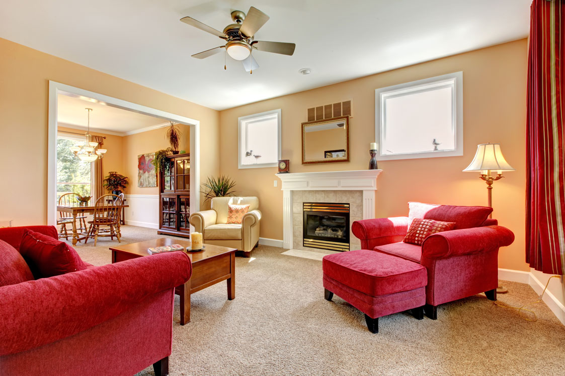 Beautiful Peach and Red Living Room Interior With Fireplace and Red Furniture